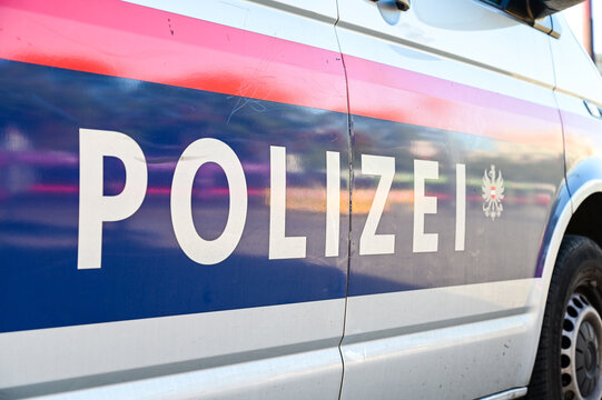 Police patrol car parked on the street in Vienna, Austria. Austrian police car on the street. Side view of a police car with the lettering "Polizei". 
