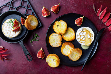 Baked Brie or Camembert cheese with toasted bread and fresh figs. Fall, autumn appetizer platter recipe