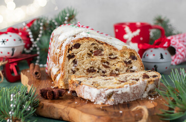 Christmas German Stollen on wooden board on gray background. Traditional treats. Close up