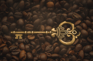 A beautiful antique key close-up against a coffee background. Macro photograph of an antique key. Vintage door key