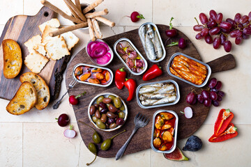 Tinned fish charcuterie board. Seacuterie appetizers platter with canned fish and seafood. Food...