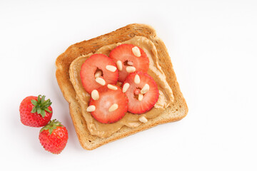 Sweet sandwich with strawberries and peanut butter on light background. Flat lay, copy space.