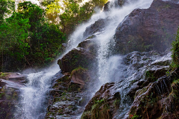 Water splashing through the rocks and forest forming a beautiful waterfall in Minas Gerais, Brazil