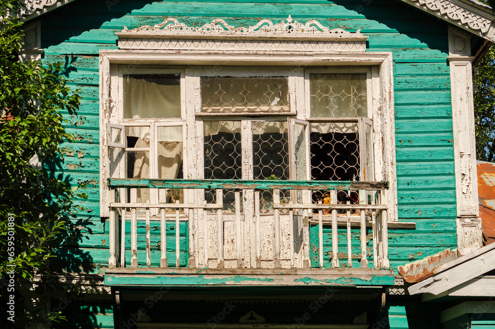 Wall mural An old Russian wooden house with carved platbands