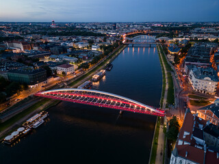 Krakow, Poland, aerial view of the Kazimierz and Podgorze districts with Vistula river bridges in the night - 659506442