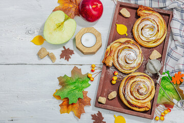 Apple roses pie with sugar powder. Traditional autumn baking, fall decor, flat lay