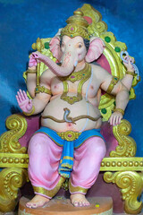 Sculpture of Ganesha sitting on a throne in an Indian temple