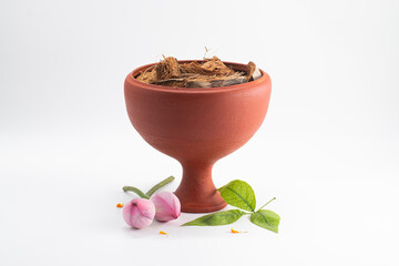 DHUNUCHI WITH DECORATIVE FLOWER THALI.ISOLATED ON WHITE.
