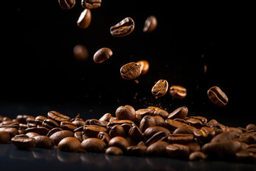Brown roasted coffee beans on dark background, close up