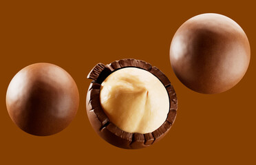 Heap of  hazelnuts dragees in chocolate isolated on white background.  chocolate balls candies filled with nuts. 3d illustration. 
