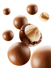 Heap of  hazelnuts dragees in chocolate isolated on white background.  chocolate balls candies filled with nuts. 3d illustration. 
