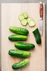 Fresh organic cucumbers on cutting board.