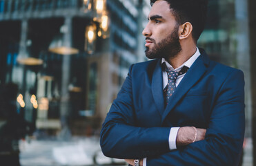 Pensive adult ethnic employee thinking about career goals in office