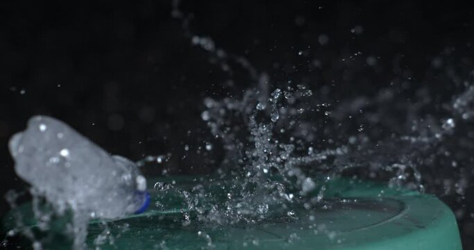 Exploding of plastic bottle of water in super slow-motion 800 fps, captured in high-speed. Shooting object with bullet