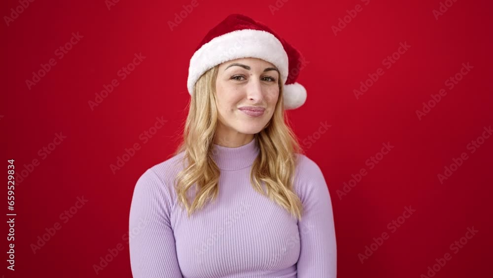 Sticker young beautiful hispanic woman wearing christmas hat saying yes with head over isolated red backgrou