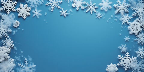Frame made of snow with snowflakes and ice crystals on blue background, top view with space for text