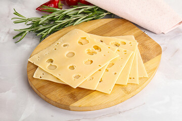 Sliced maasdam cheese with holes