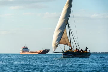 Foto auf Acrylglas Zanzibar seafarers on a dhow the traditional sailing vesssels of zanzibar tanzania