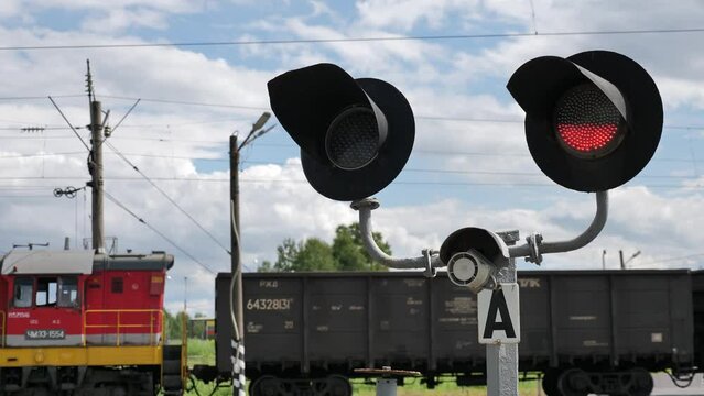 Train Passing Red Traffic Light Flashing At Railroad Crossing. Signs Warning