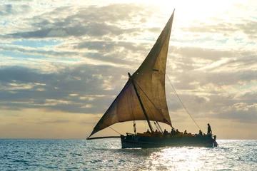 Muurstickers dramatic skyline with the dhow a traditional sailing vesssels of zanzibar tanzania © mikefoto58