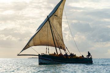 Fototapeta premium dramatic skyline with the dhow a traditional sailing vesssels of zanzibar tanzania