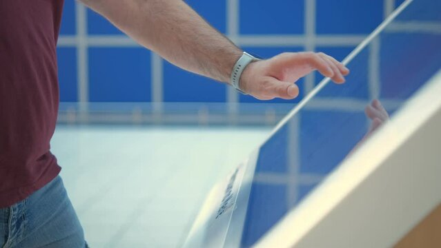 Man using a touch terminal in a shopping mall. The concept of people and technologies. Online Router