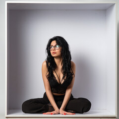 Young sexy slim woman in the cube.
