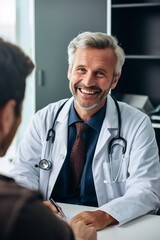 Smiling middle-aged male doctor in white coat conversing with a patient in a modern clinic