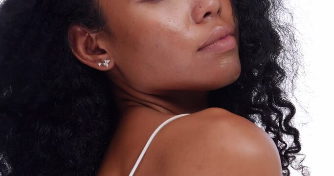 Portrait of a black girl with curly hair, soft makeup and perfect skin. Beautiful face of young black woman with natural skin.