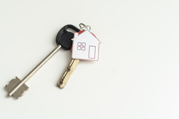 key chain with house symbol and keys on white background, Real estate concept