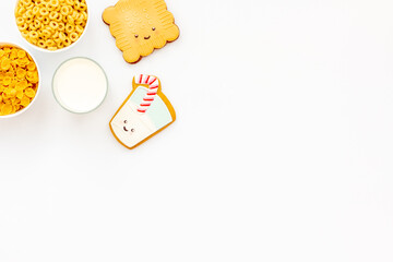 Kids breakfast with milk and funny cookies with cornflakes
