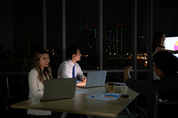 Group of broker international stock traders working actively at night in office, Everyone is...