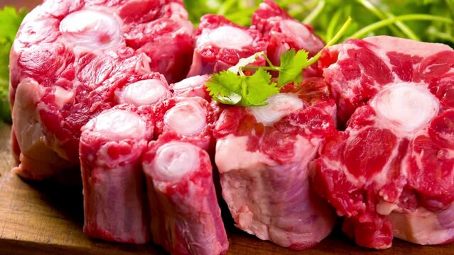Close-Up of Raw Oxtail Meat Pieces on Wooden Surface | 4K Video of Fresh Ingredients for Savory Delights