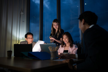 Group of business people working in office at night. Business concept.
