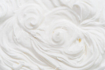 Creamy waves and swirls in yoghurt or cream surface. Top view.