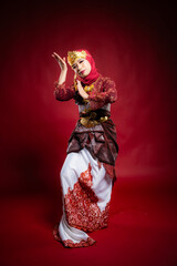An Asian female traditional damcer wearing a traditional apparel and accessories dancing the traditional dance