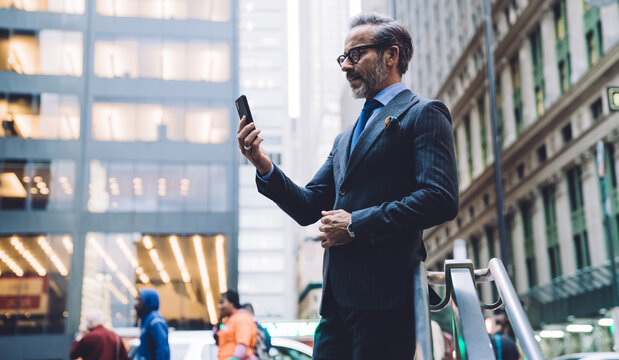 Businessman in dark business suit talking on video