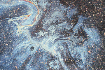 Marble texture of gasoline spill from a car on wet asphalt - obrazy, fototapety, plakaty