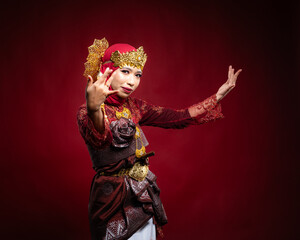 An Asian female traditional damcer wearing a traditional apparel and accessories dancing the traditional dance