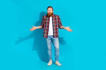 Full body photo of confused guilty man with red beard dressed checkered shirt jeans shrugging...