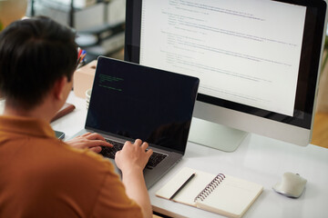 Software developer testing programming code to identify bugs or errors