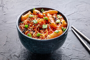 Rabokki, tteokbokki or topokki with ramen, Korean street food, spicy rice cakes in red pepper gochujang sauce, a popular dish