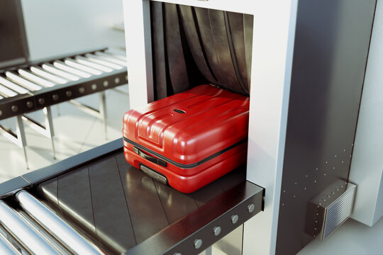 A red suitcase entering an airport scanner on a conveyor belt. Security check