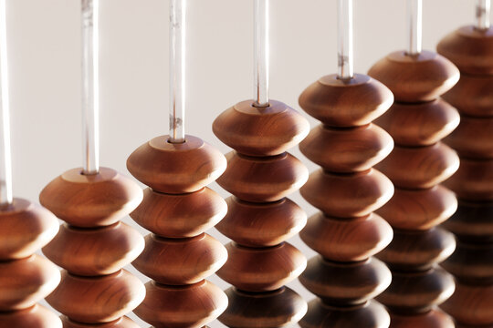 A vintage wooden abacus with beads and metal wire, perfect for counting