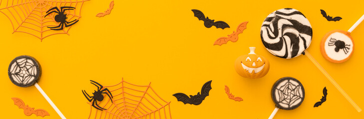 Halloween concept - creative backgrtound with festive sweets, spiders, bats
