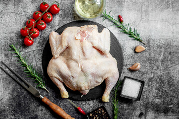 whole raw chicken on a stone background 