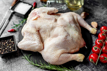 whole raw chicken on a stone background 