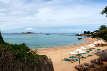 Sea beach landscape with beach umbrellas and beach chairs.