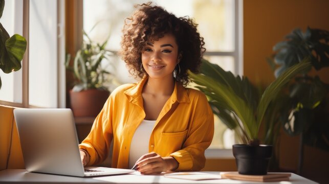 Young Smiling Ethnic Woman Making Call Via Smartphone While Working Remotely From Home