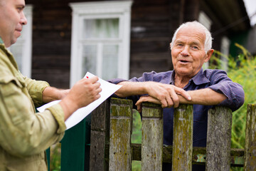 Senior man talking with real estate manager outdoors